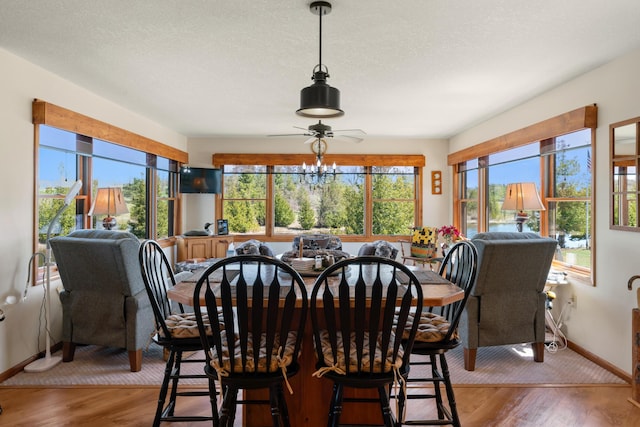 dining area with light wood-style flooring and baseboards