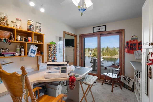 home office featuring light colored carpet and a ceiling fan