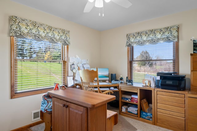 home office featuring visible vents and a ceiling fan