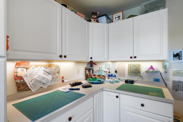 kitchen featuring white cabinetry and light countertops