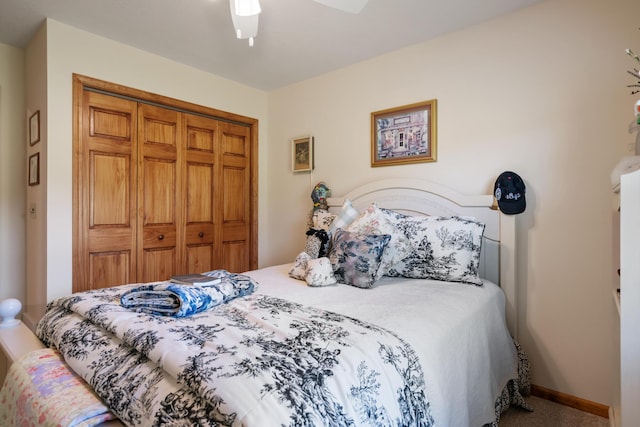 carpeted bedroom with ceiling fan and a closet