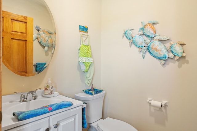 bathroom with toilet and vanity