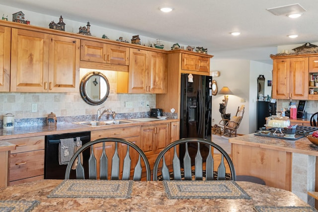 kitchen featuring a sink, tasteful backsplash, black appliances, recessed lighting, and light countertops