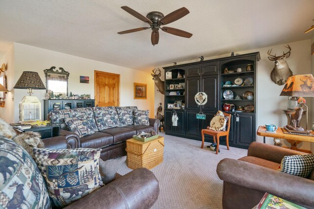 living room with ceiling fan and light colored carpet