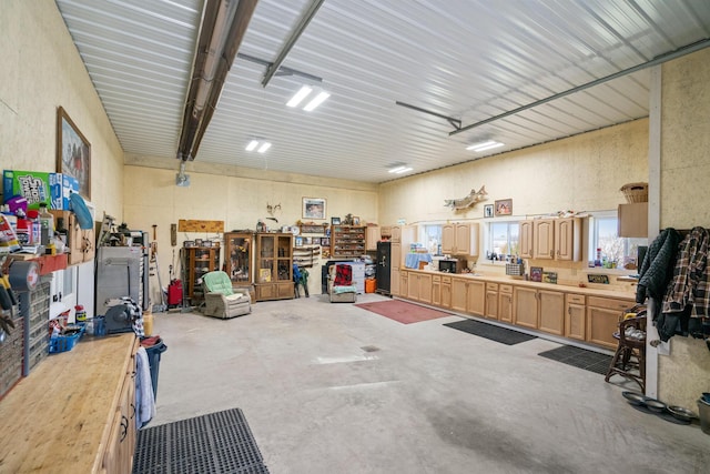 garage with a workshop area and refrigerator