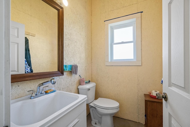 half bathroom featuring toilet and a sink