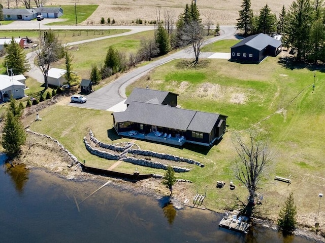 birds eye view of property featuring a water view and a rural view