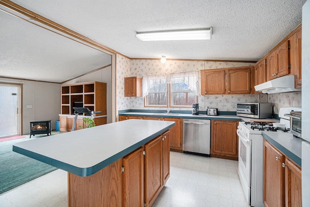 1580 Bancroft St, Cheboygan, MI 49721 - kitchen featuring wallpapered walls, vaulted ceiling, appliances with stainless steel finishes, and light floors