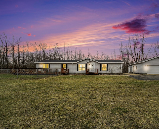 1580 Bancroft St, Cheboygan, MI 49721 - view of front of property featuring a detached garage, a front yard, fence, and aphalt driveway