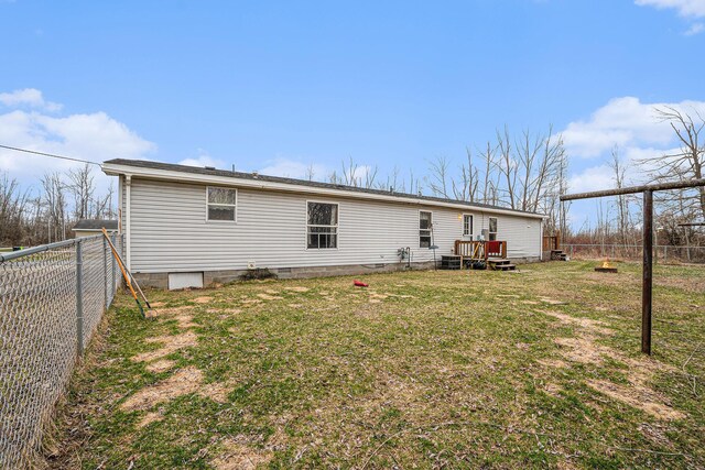 1580 Bancroft St, Cheboygan, MI 49721 - rear view of house with a fenced backyard, crawl space, and a yard