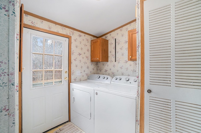 1580 Bancroft St, Cheboygan, MI 49721 - clothes washing area with wallpapered walls, washer and clothes dryer, ornamental molding, and cabinet space