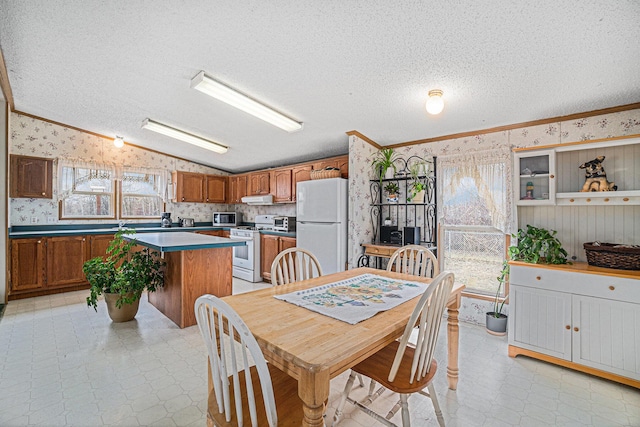 1580 Bancroft St, Cheboygan, MI 49721 - dining room with wallpapered walls, a textured ceiling, ornamental molding, and light floors