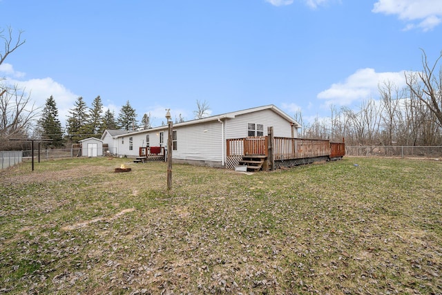 1580 Bancroft St, Cheboygan, MI 49721 - back of house featuring a fenced backyard, a wooden deck, crawl space, and a yard