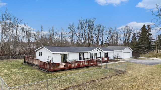1580 Bancroft St, Cheboygan, MI 49721 - view of front of house featuring fence, a shingled roof, driveway, an outbuilding, and a deck