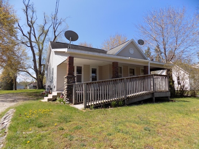 317 Pine Hill Ave, Cheboygan, MI 49721 - view of front of property with a front lawn and a porch