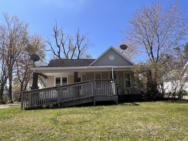 317 Pine Hill Ave, Cheboygan, MI 49721 - back of house featuring a lawn and a porch