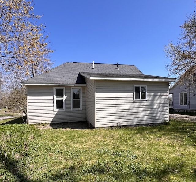 317 Pine Hill Ave, Cheboygan, MI 49721 - back of house featuring a yard