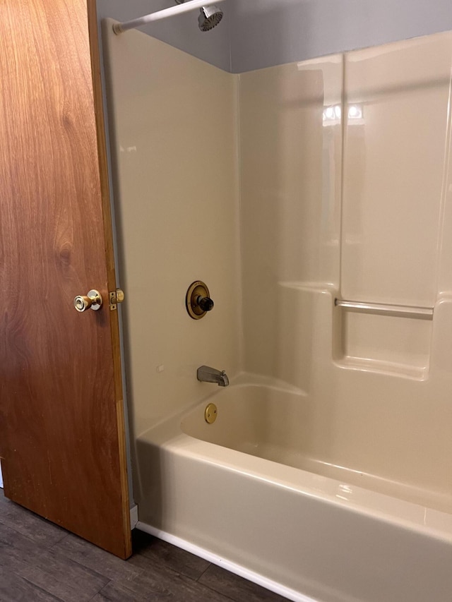 317 Pine Hill Ave, Cheboygan, MI 49721 - bathroom with wood finished floors and bathtub / shower combination