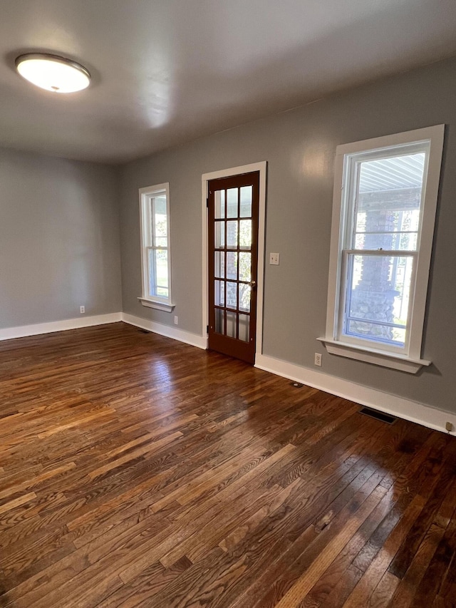 317 Pine Hill Ave, Cheboygan, MI 49721 - spare room featuring dark wood-style floors and baseboards