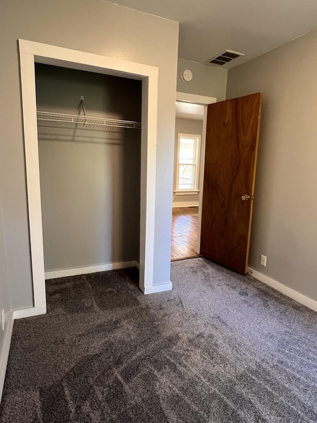 317 Pine Hill Ave, Cheboygan, MI 49721 - unfurnished bedroom with carpet floors, a closet, and baseboards