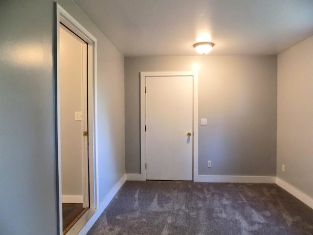 317 Pine Hill Ave, Cheboygan, MI 49721 - unfurnished room with dark colored carpet and baseboards