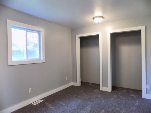 317 Pine Hill Ave, Cheboygan, MI 49721 - unfurnished bedroom featuring dark carpet