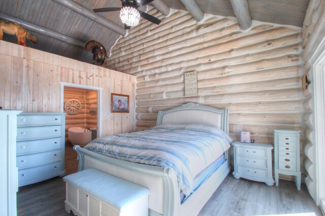 bedroom with rustic walls, wood finished floors, wood ceiling, beamed ceiling, and high vaulted ceiling