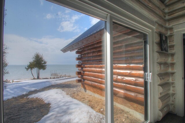 exterior space with a water view and log exterior