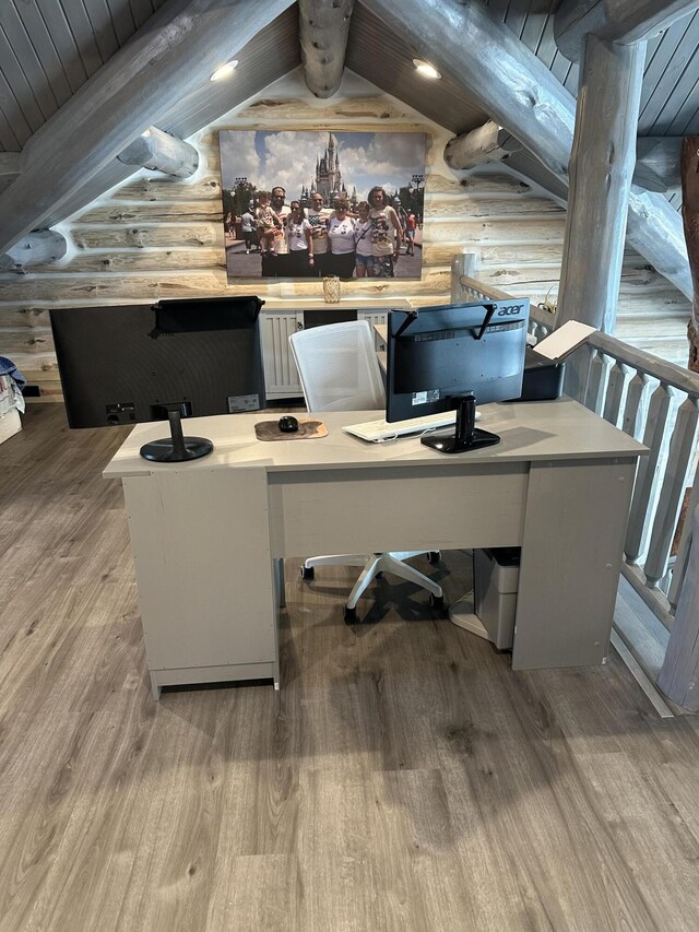 office area with lofted ceiling with beams, rustic walls, wooden ceiling, and wood finished floors