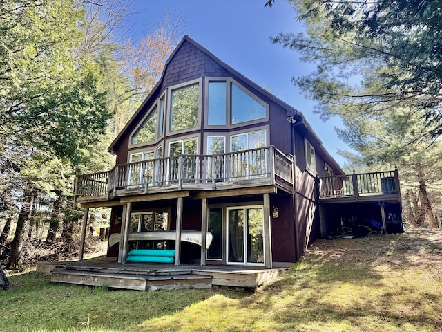 2330 Kirkland Dr, Grayling, MI 49738 - rear view of house with a wooden deck and a yard