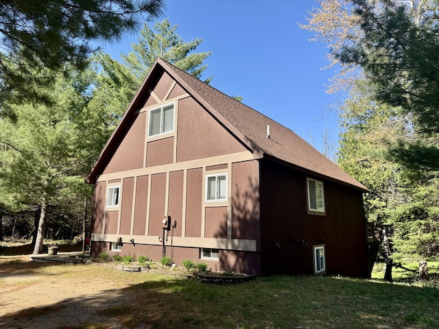 2330 Kirkland Dr, Grayling, MI 49738 - view of home's exterior with a yard and a shingled roof