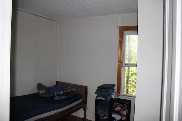 bedroom featuring multiple windows and crown molding