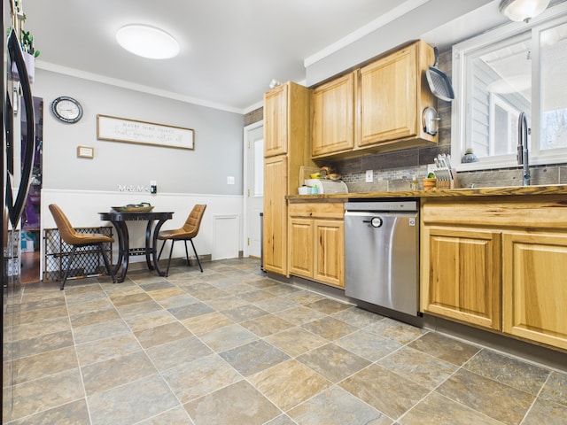 kitchen featuring tasteful backsplash, stainless steel dishwasher, stone finish floor, ornamental molding, and a sink
