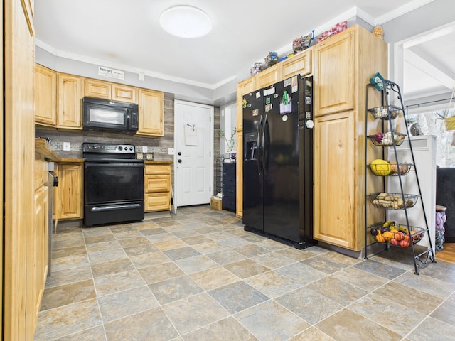 kitchen with light brown cabinetry, stone finish flooring, and black appliances