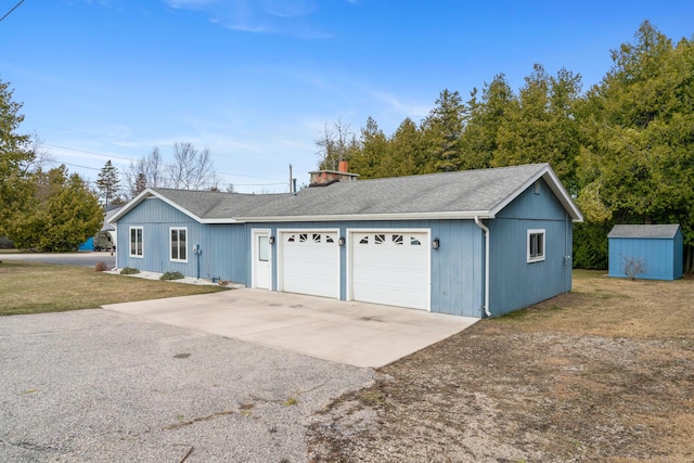198 W Spruce St, Saint Ignace, MI 49781 - garage featuring driveway and a storage shed