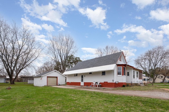 view of home's exterior with driveway, an outdoor structure, a shingled roof, a lawn, and a garage