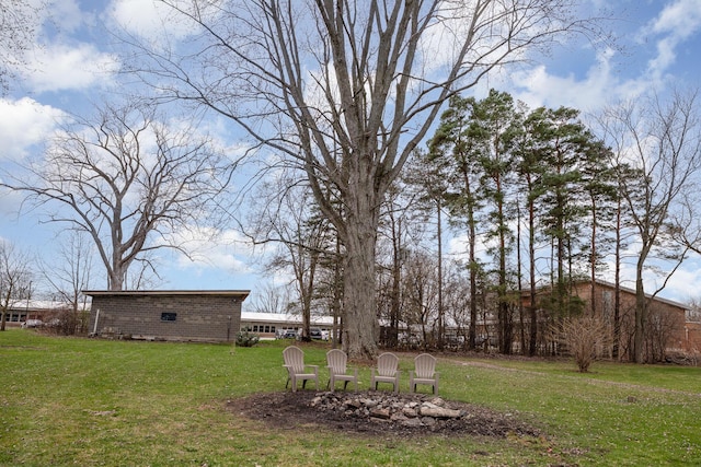 view of yard with a fire pit
