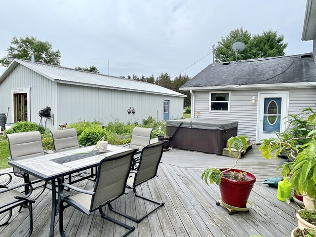 wooden terrace featuring outdoor dining area and a hot tub
