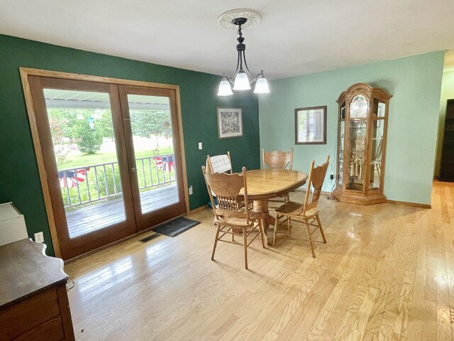 dining space with light wood-type flooring, french doors, and visible vents