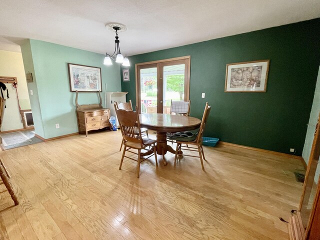dining room featuring light wood-type flooring and baseboards