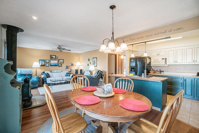 dining room featuring light wood finished floors and ceiling fan