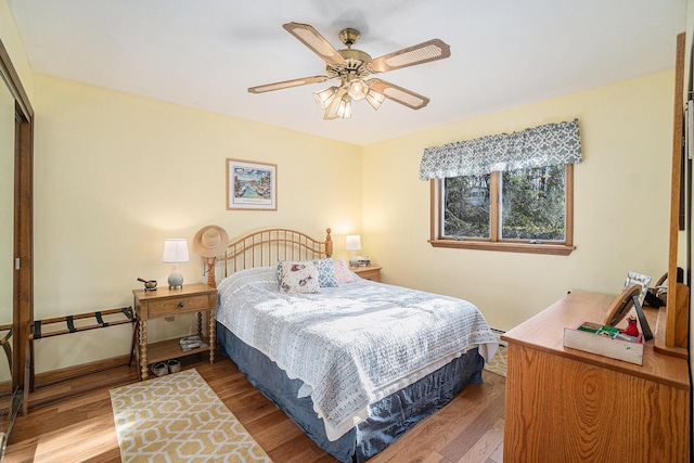 bedroom with a closet, ceiling fan, and wood finished floors
