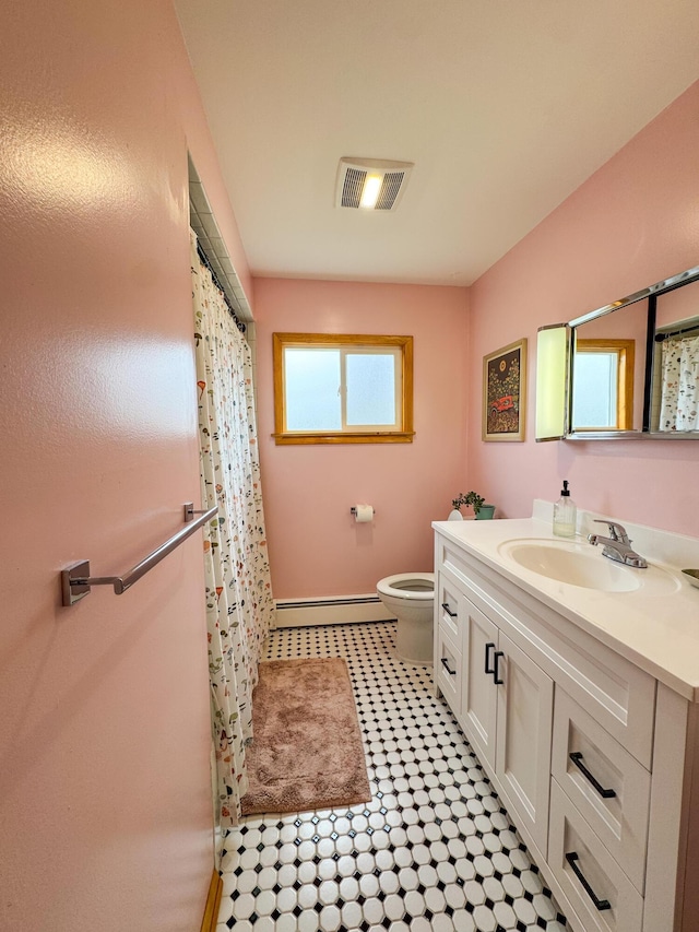 full bath with visible vents, vanity, a baseboard radiator, baseboards, and toilet
