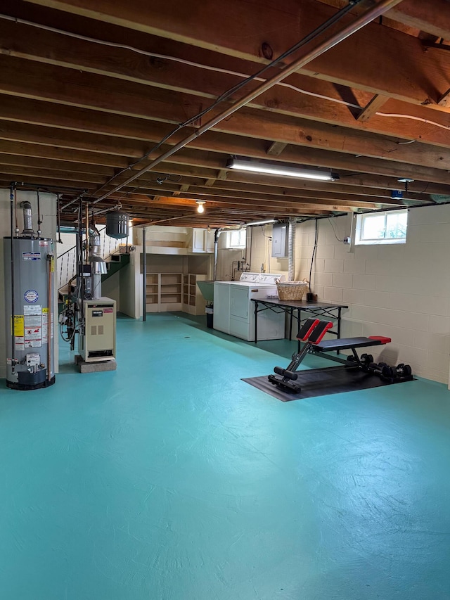 basement with stairs, gas water heater, electric panel, and washing machine and dryer