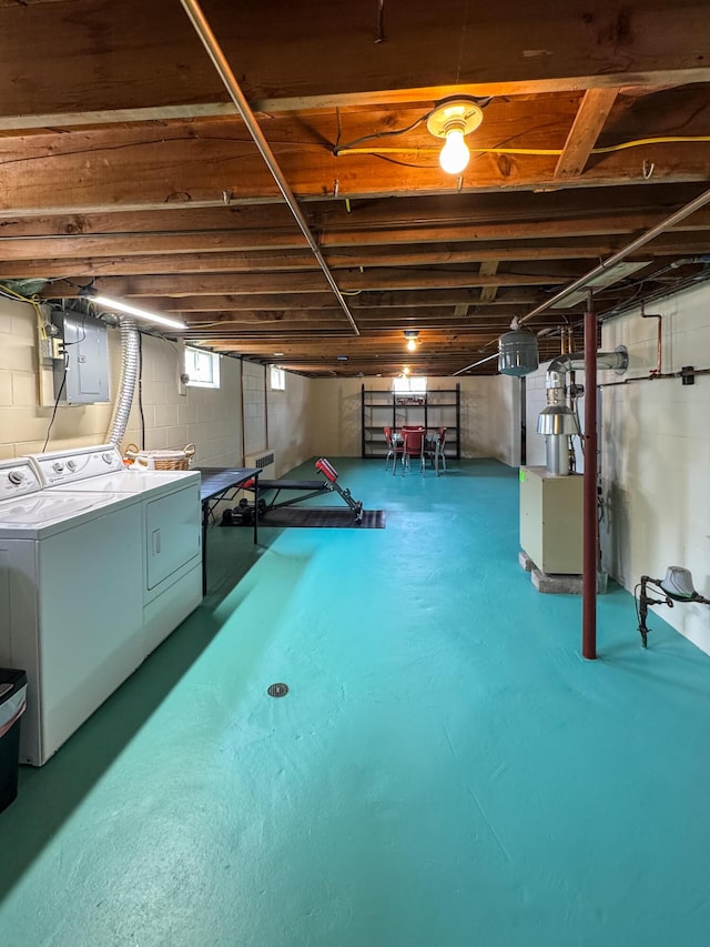 basement featuring separate washer and dryer and electric panel
