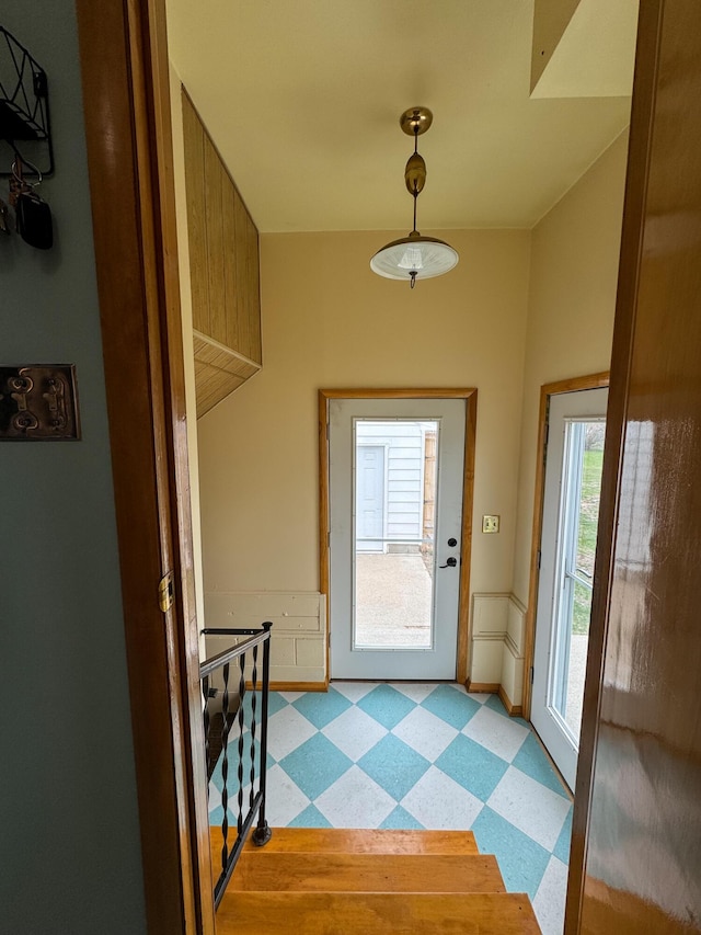 doorway to outside featuring plenty of natural light and light floors