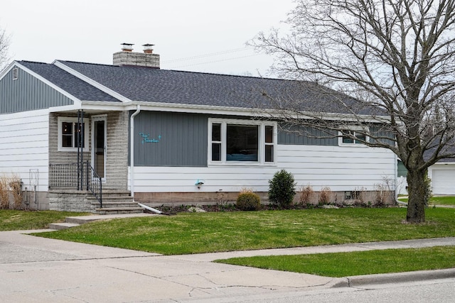 single story home featuring roof with shingles, a chimney, and a front yard