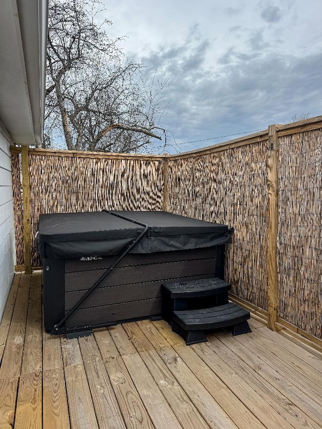 wooden terrace with a hot tub
