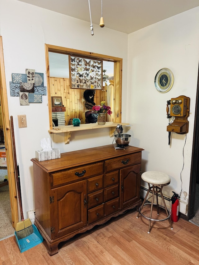 17745 Shubert Hwy, Alpena, MI 49707 - detailed view of wood finished floors and a fire extinguisher