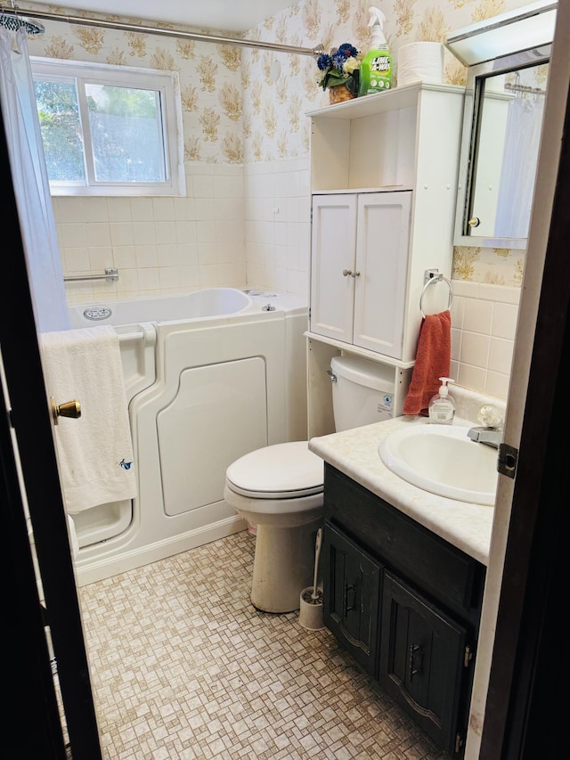 17745 Shubert Hwy, Alpena, MI 49707 - bathroom featuring wallpapered walls, a garden tub, wainscoting, tile patterned floors, and vanity